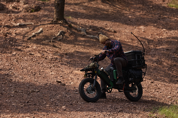 Side view of the Pawkymo electric bike with detachable racks, offering customizable cargo options for outdoor activities and camping gear transportation.